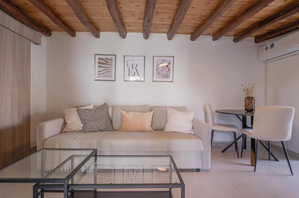 a living room with a couch and a table at Phaedrus Living: Peristerona Traditional Maisonette in Peristerona