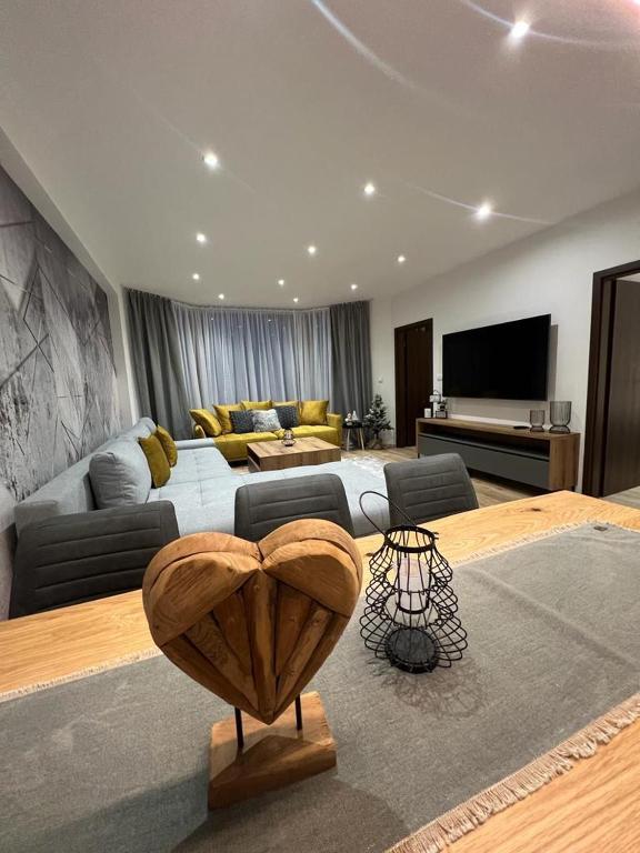 A television and/or entertainment centre at LUX apartmany Romantika CHOPOK 7, 19