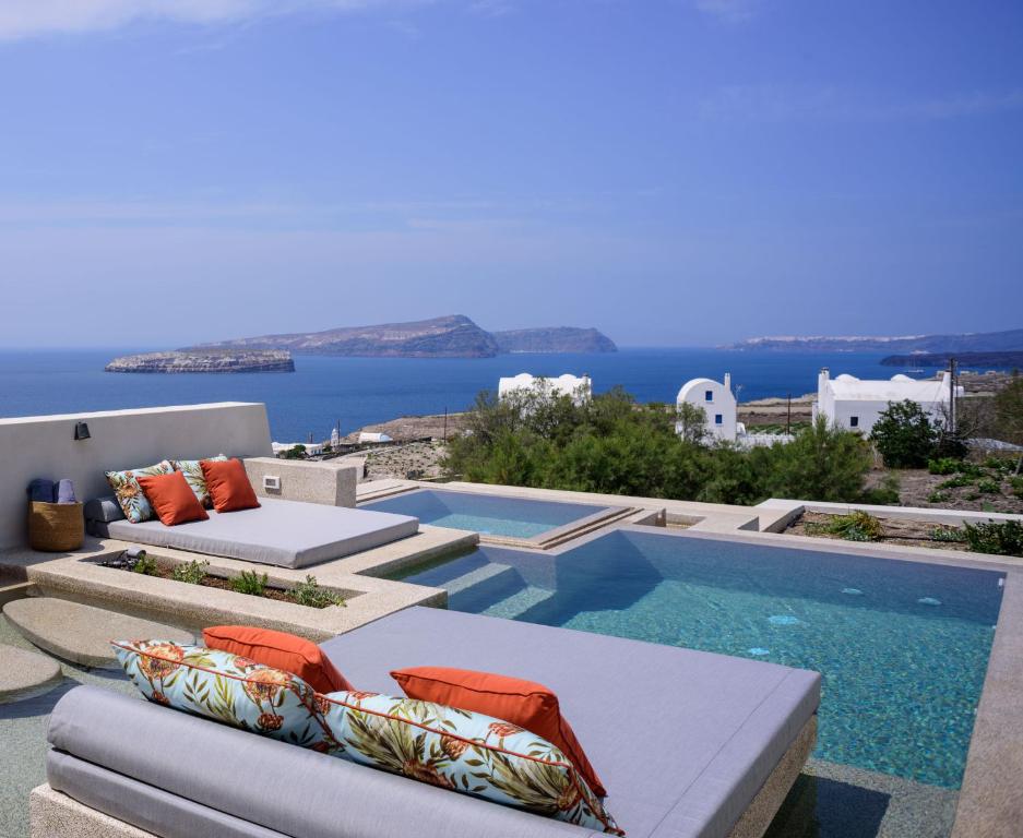 a villa with a pool and a view of the ocean at 11:11 By Potnia in Akrotiri
