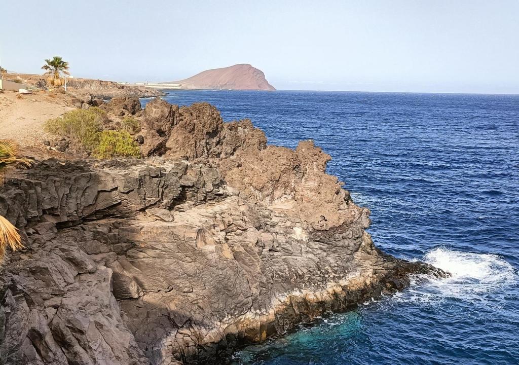 a view of the ocean and a rocky coastline at Gota de Mar in Los Abrigos