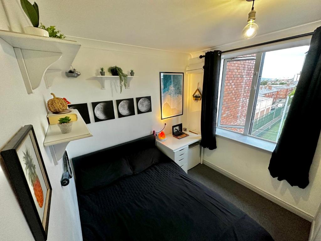 a small bedroom with a bed and a window at Custom House, 1 room, Dublin 1 in Dublin
