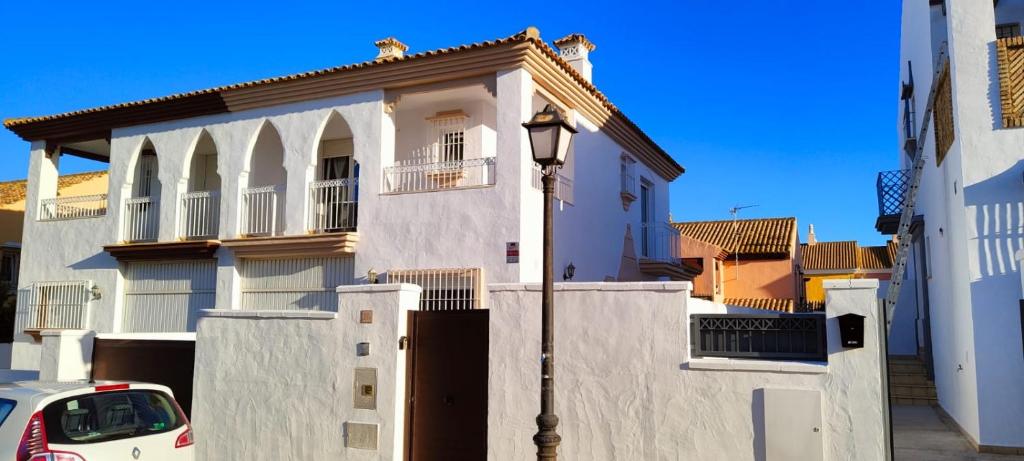 a white house with a street light in front of it at La Tahona 27-H in Zahara de los Atunes