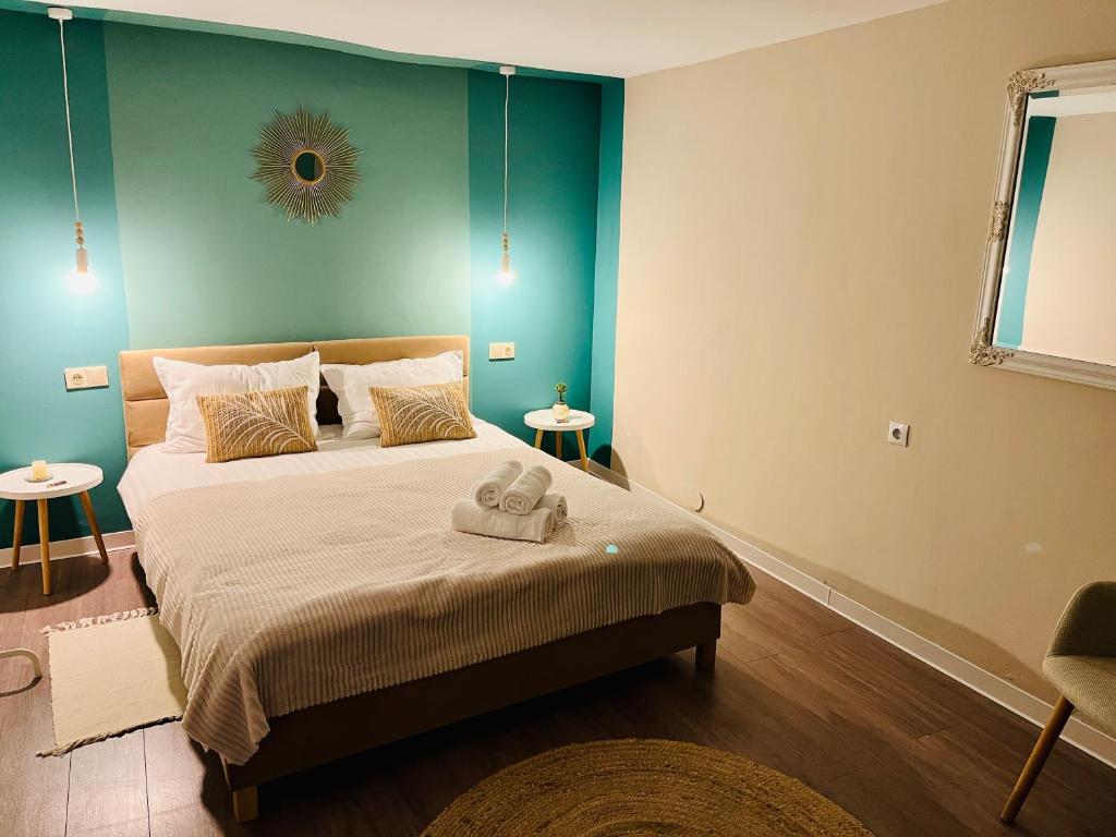 a bedroom with a bed with a towel on it at Moon and Sun Apartments in Sibiu