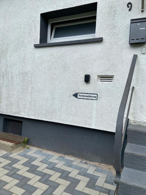 a white building with a sign on the side of it at Naturpanorama in Gleiszellen-Gleishorbach