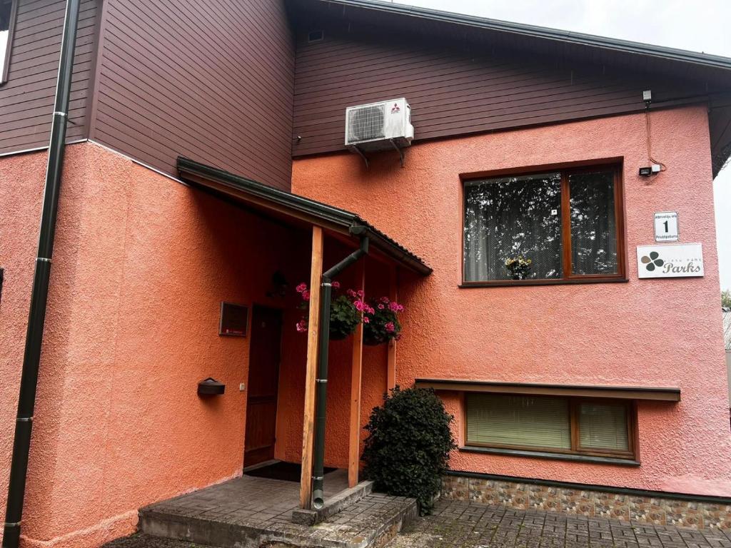 a house with an open door and a window at Parks Guest House in Sigulda