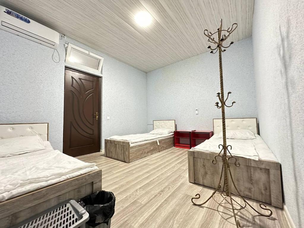 a hospital room with two beds and a crossurrectionurrectionurrectionurrectionurrectionurrectionurrection at Stay hostel in Tashkent