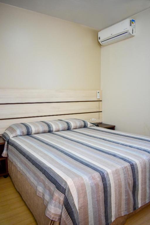 Postel nebo postele na pokoji v ubytování Barigui Park Hotel