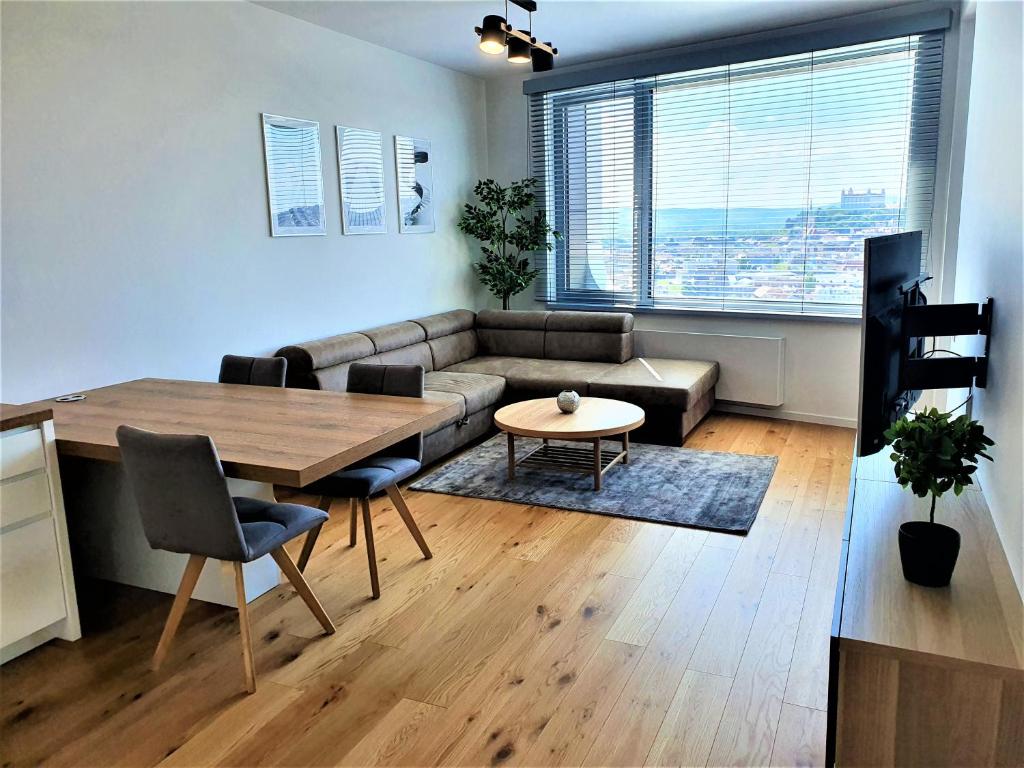 a living room with a couch and a table at Prestigious SKY PARK apartment - City view - Traveller awards 2024 in Bratislava