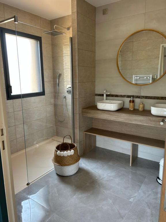 a bathroom with a shower and a sink and a mirror at Sol&#39;m Lodges in Solesmes