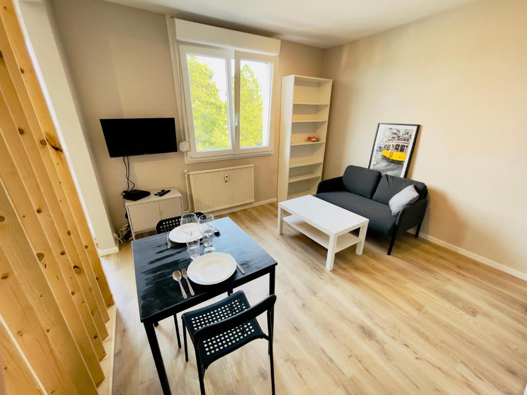 een woonkamer met een bank en een tafel bij Studio 43aJJ in Lure