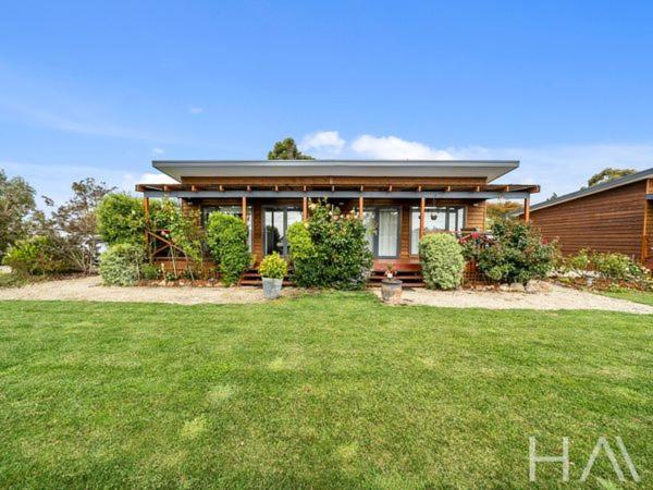 a house with a grass yard in front of it at Harrison Grove in Forcett