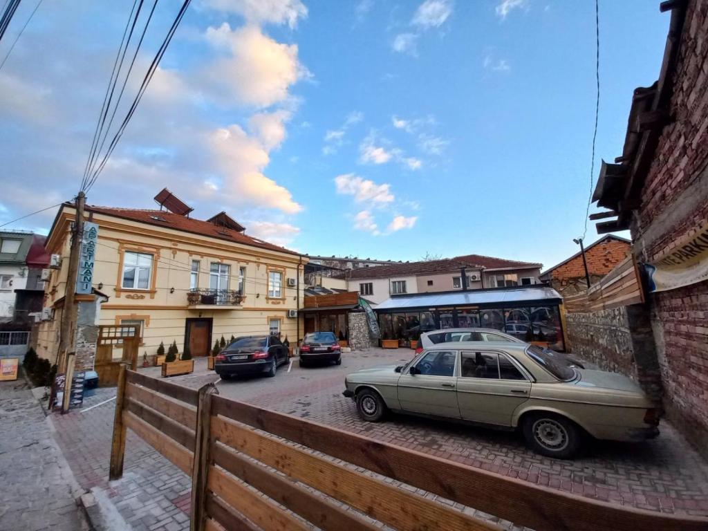 a car parked on a street next to a building at Rooms Filip in Bitola