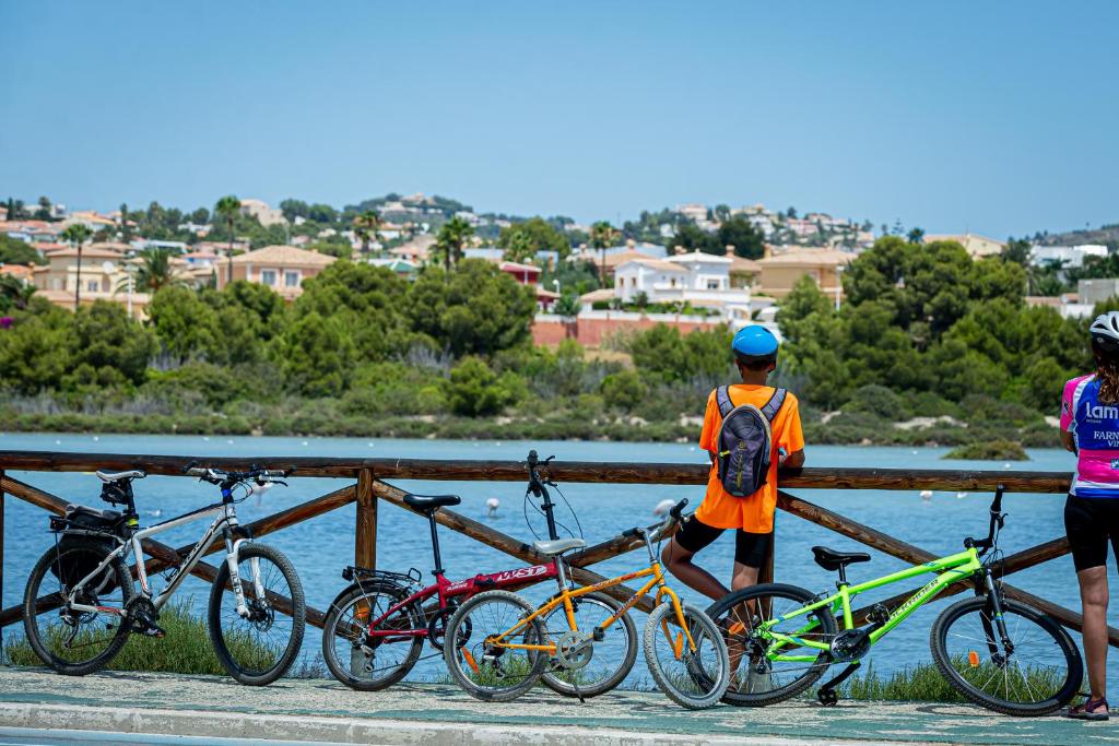 a group of bikes parked next to a fence at AR Roca Esmeralda & SPA Hotel in Calpe