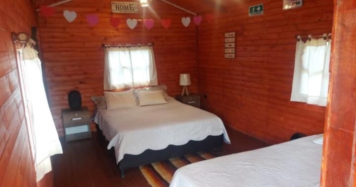 Postel nebo postele na pokoji v ubytování Mundo Nuevo Cabañas