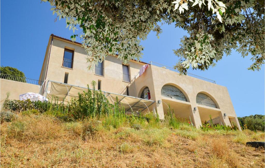 a building on top of a grassy hill at Beautiful Apartment In Piana With Wifi in Piana