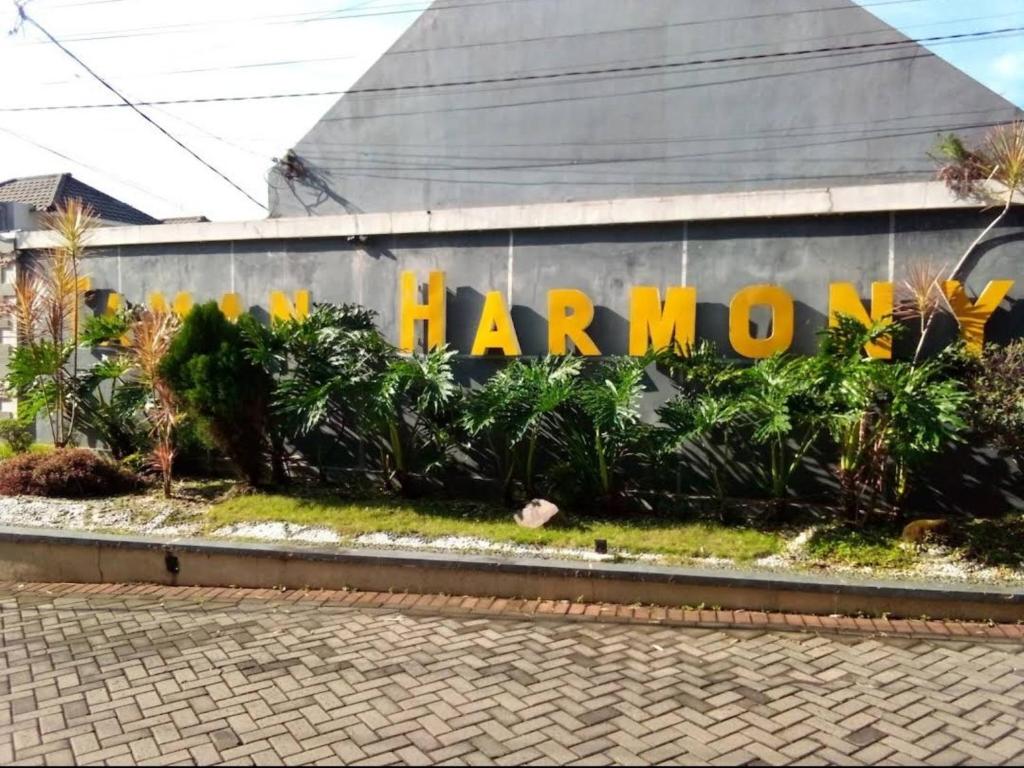 a mural on the side of a building with the words harong at Family Villa Syariah C-33 with minipool in Batu