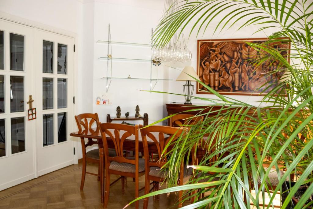 a dining room with a table and chairs and a plant at Elegance ,Space & Luxury in Brussels in Brussels