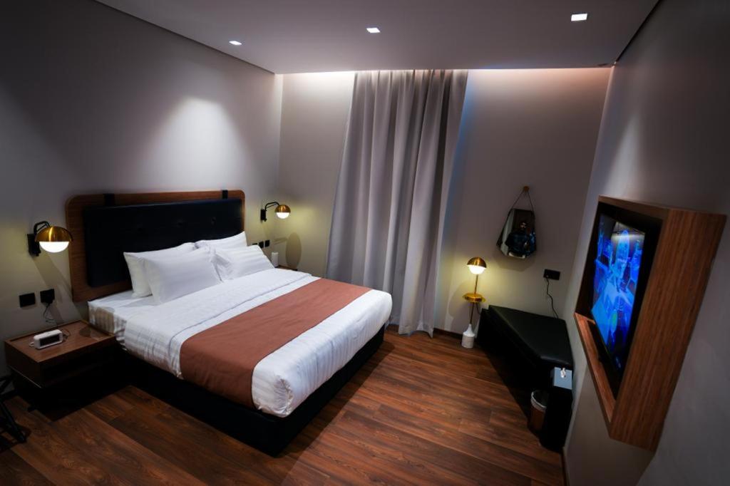 Postel nebo postele na pokoji v ubytování NAS Hotel
