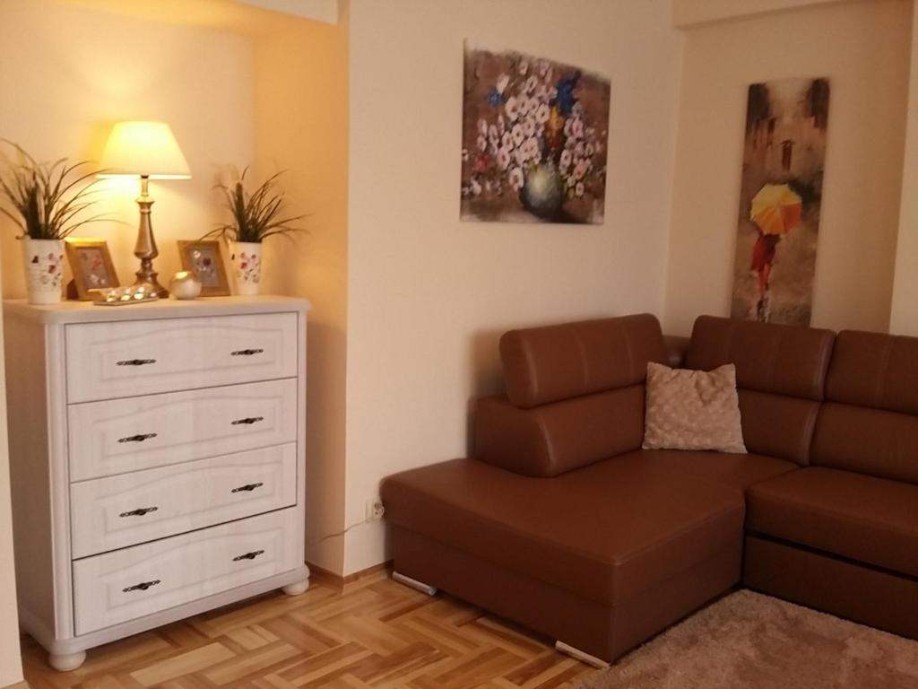 a living room with a couch and a dresser at Warsaw Kredytowa Apartment in Warsaw