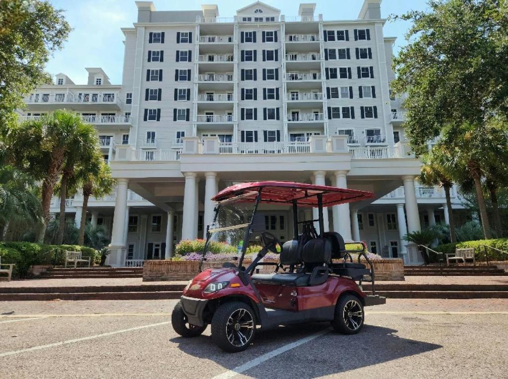 a golf cart parked in front of a large building at Grand Sandestin 2210 in Destin