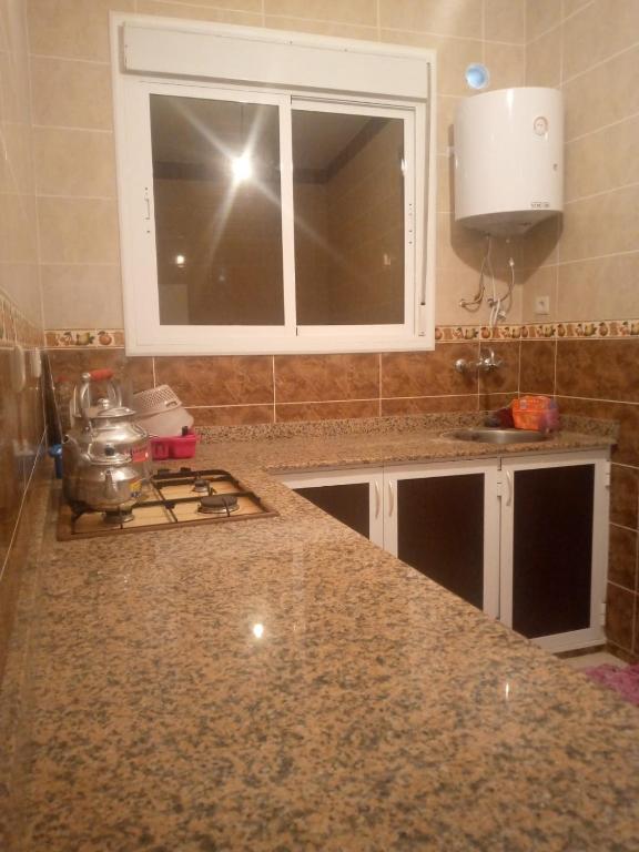 Kuchyň nebo kuchyňský kout v ubytování Appart climatisé F3