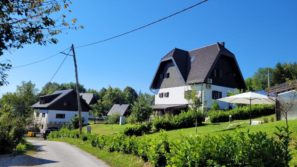 a house on a hill next to a road at Plitvica Villa Prica in Plitvička Jezera