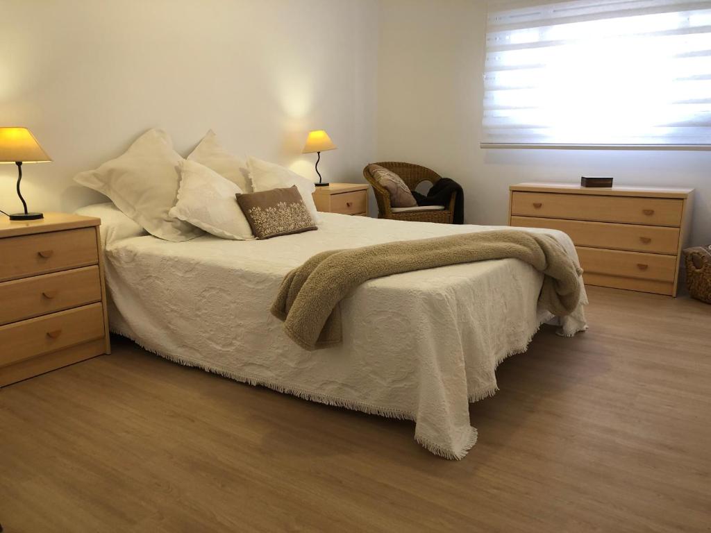 a bedroom with a bed with a blanket and a window at 3 Bed Flat - Sleeps 5 - Wifi in Bellreguart