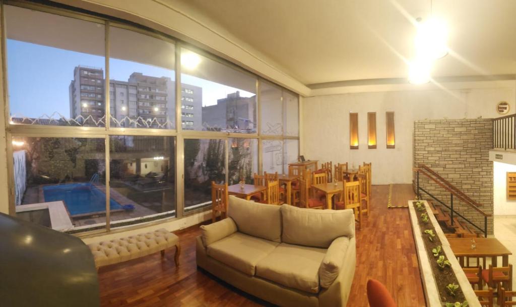 a living room with a couch and a large window at Pachá Hostel Backpack in Salta