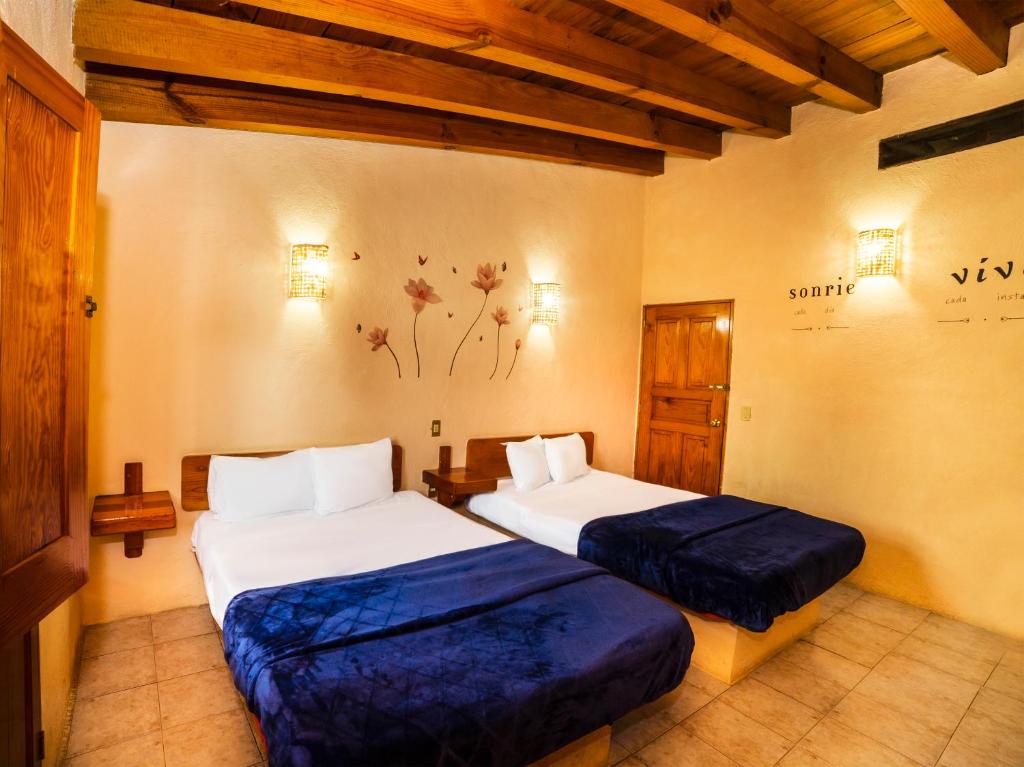 a hotel room with two beds in a room at Posada Real del Valle in Valle de Bravo