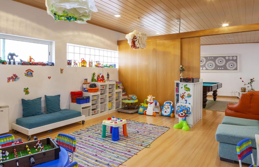 a childrens room with a couch and a table at Boutique Hotel Casa do Outeiro - Arts & Crafts in Batalha