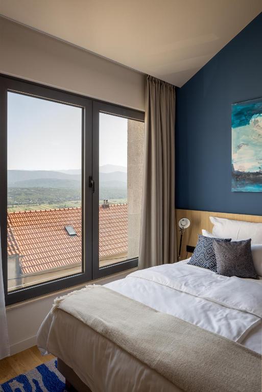 Postel nebo postele na pokoji v ubytování Emotheo Heritage Hotel