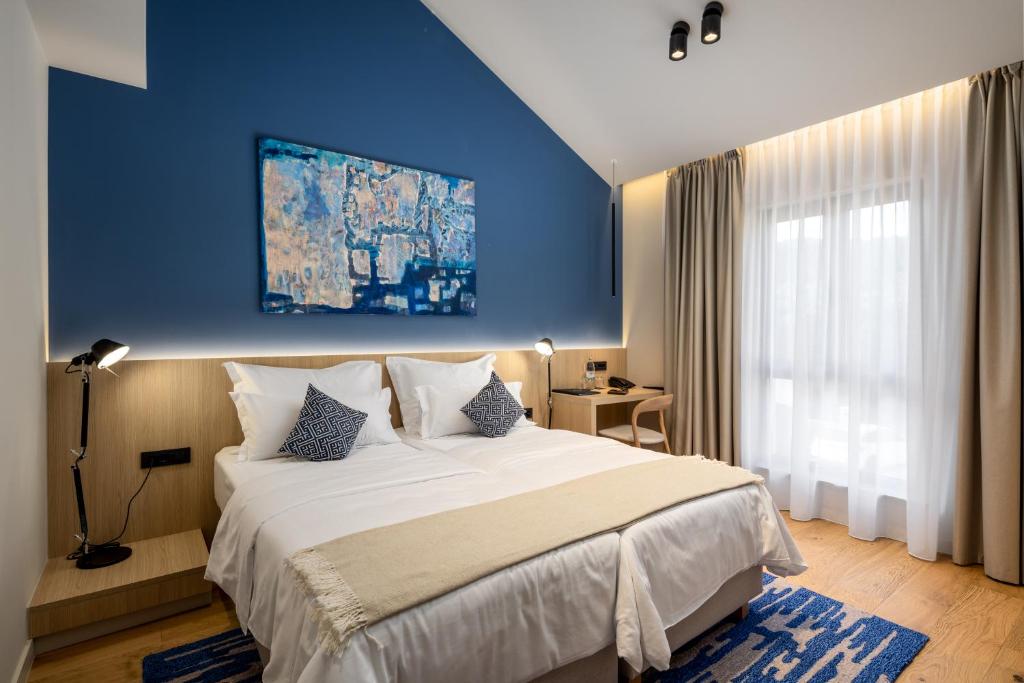 Postel nebo postele na pokoji v ubytování Emotheo Heritage Hotel