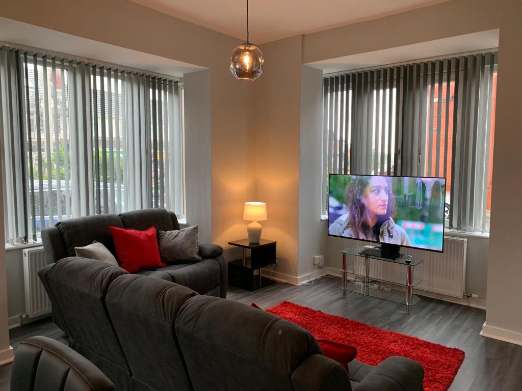 a living room with a couch and a flat screen tv at Waterloo Sunset in Blackpool