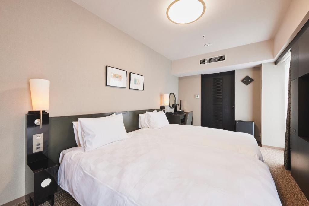 Tempat tidur dalam kamar di Richmond Hotel Nagasaki Shianbashi