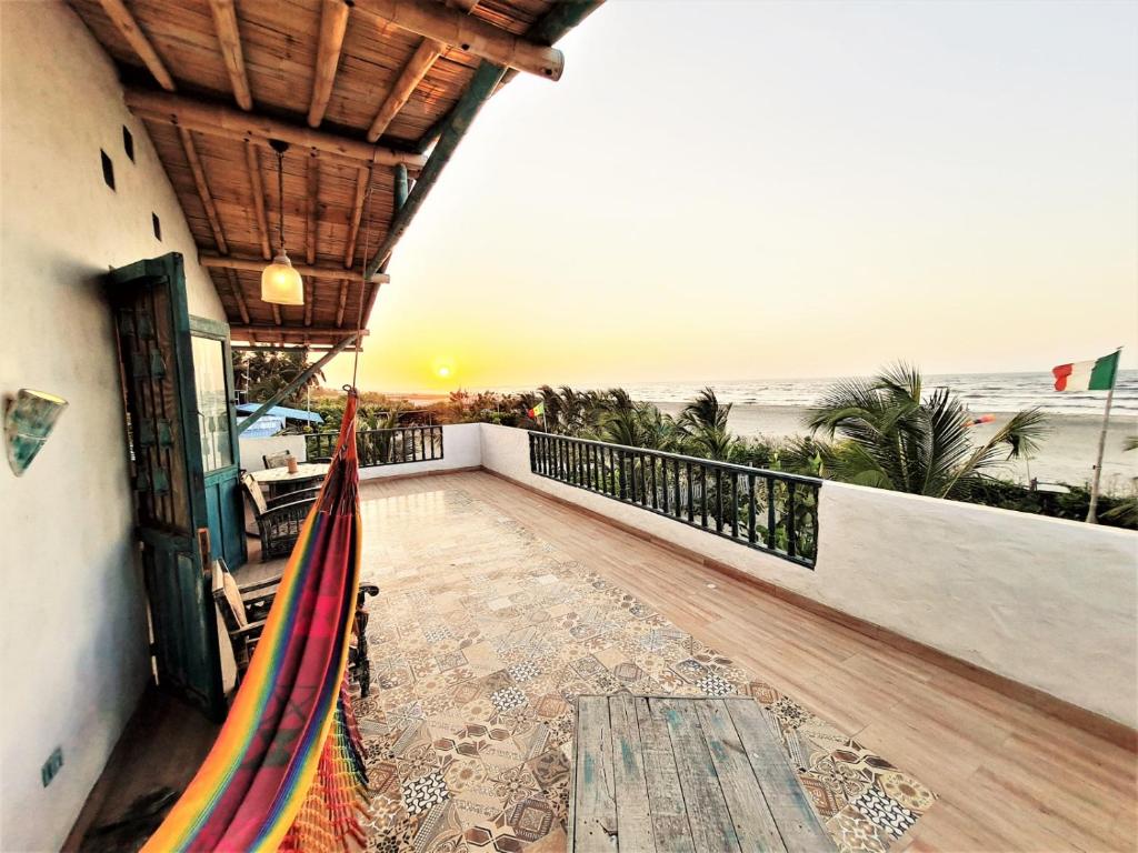 a balcony with a view of the beach at CHEVERE BEACH CABAÑAS SAS in Puebloviejo