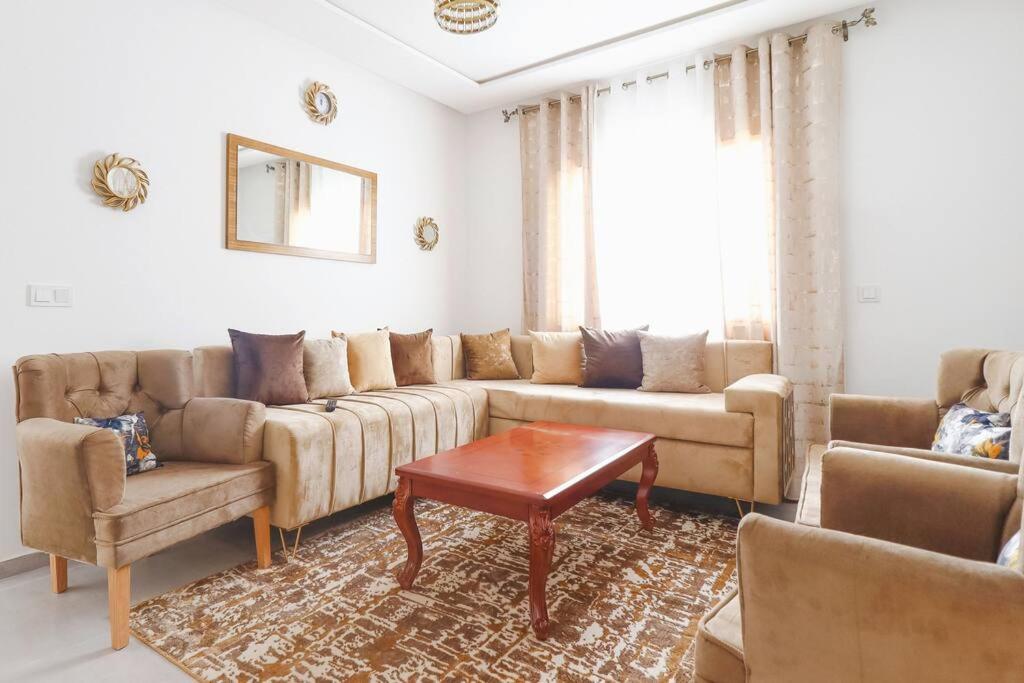 a living room with a couch and a table at Magnifique Appartement Golf Tanger for Families in Tangier