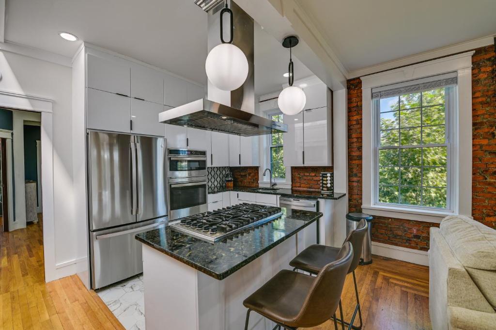 a kitchen with stainless steel appliances and a counter top at Contemporary Cohoes Retreat with Electric Fireplace! in Cohoes