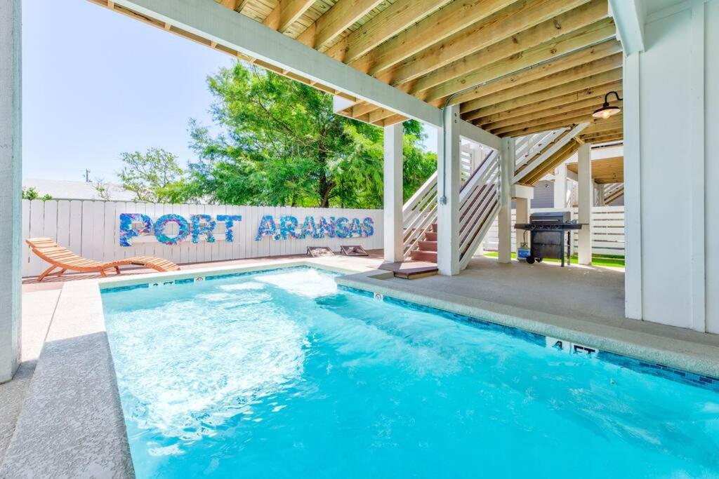 a swimming pool with a sign that reads port aransas at New Luxury Villa and Private Pool-Cart-Ocean View! in Port Aransas