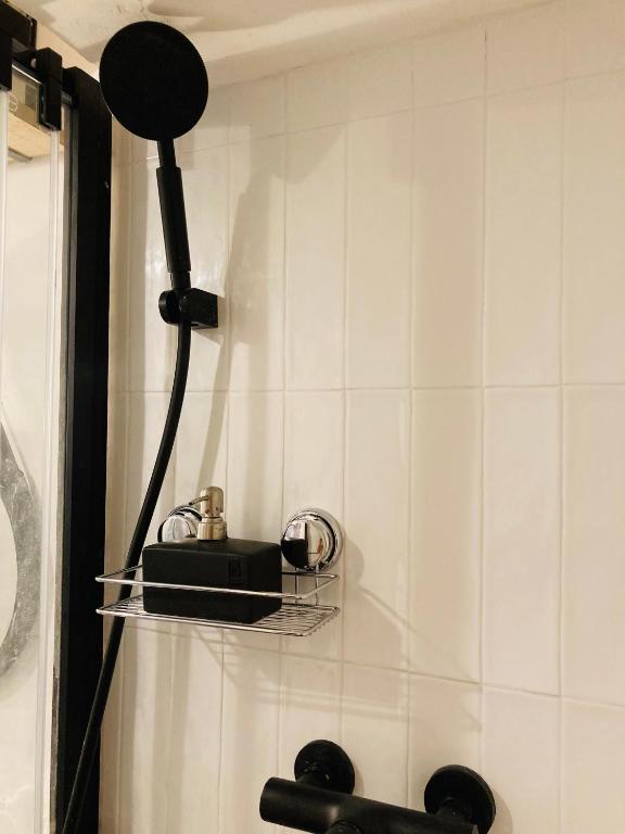 a bathroom with a shower with a black shower head at Pied à terre Méditerranéen ! in Marseille