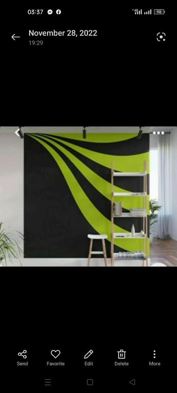 a screen with a green and black wall with a chair at Angela Avenue in Pavia