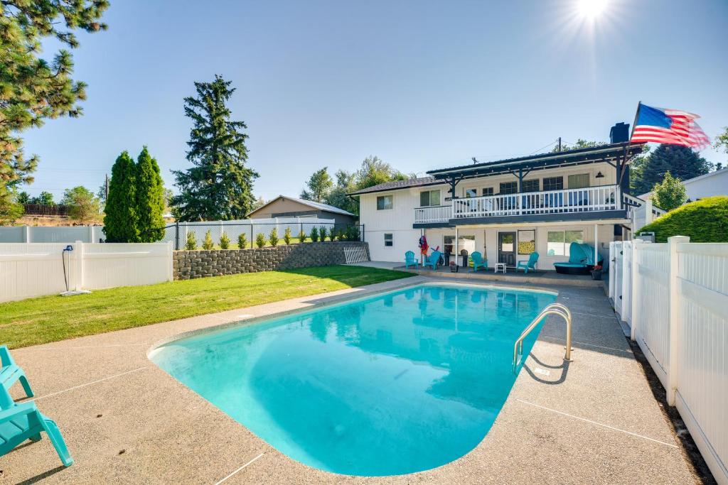 a swimming pool in the backyard of a house at Epic Family Getaway with Pool, Game Room and Fire Pit! in East Wenatchee