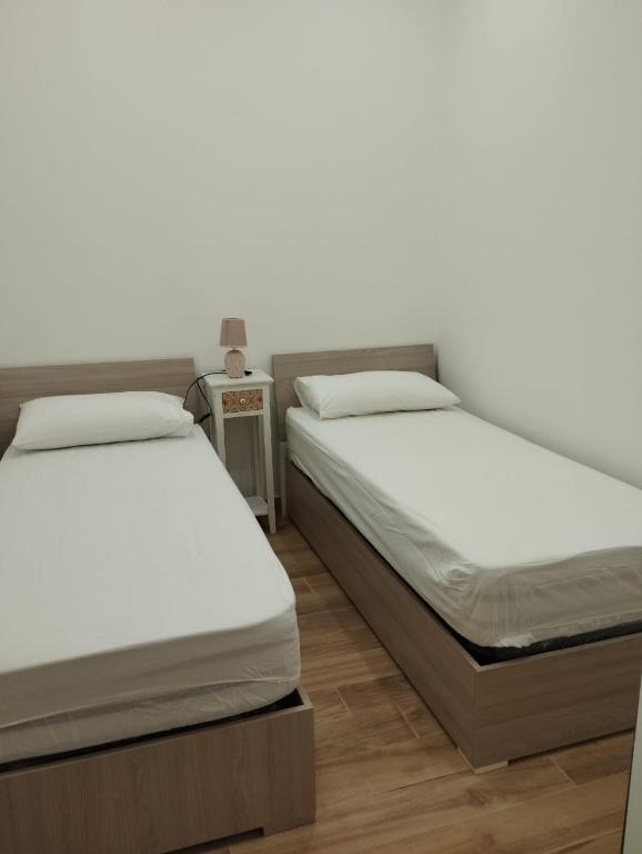 Posteľ alebo postele v izbe v ubytovaní Appartamenti Nella