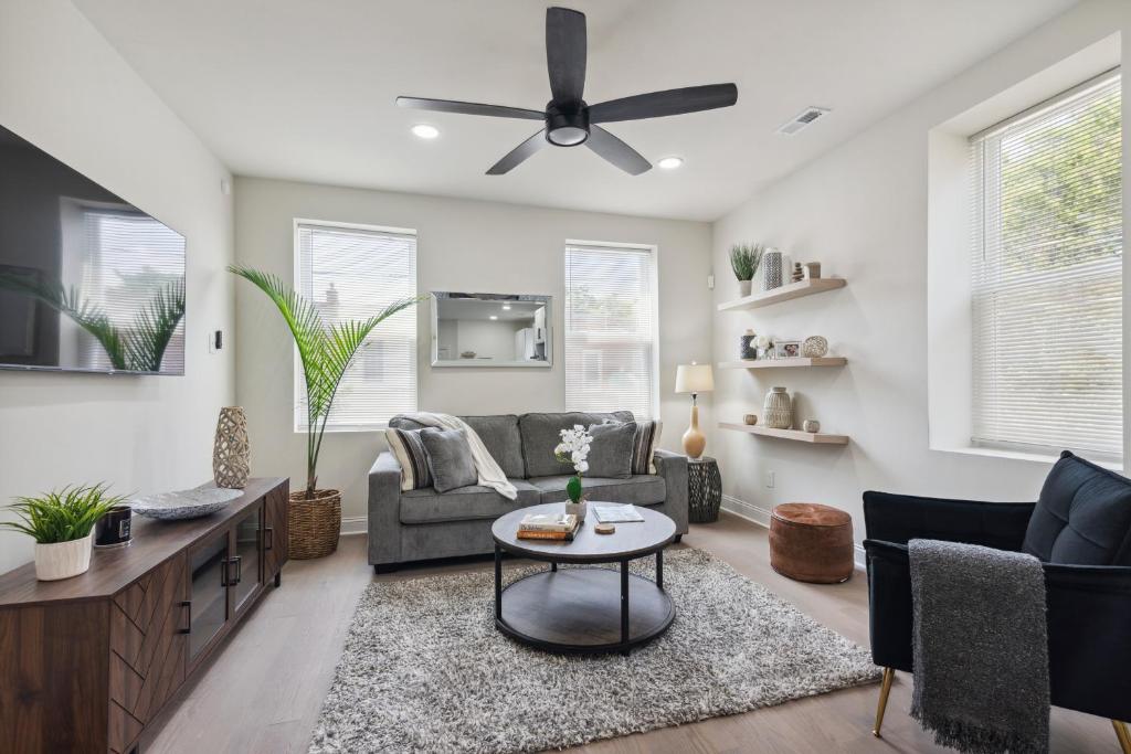 a living room with a couch and a ceiling fan at Modern City living in Philadelphia