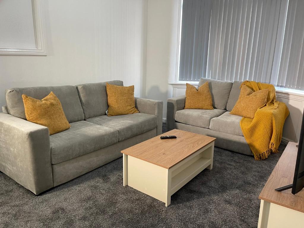 a living room with two couches and a coffee table at Entire Modern Home Middlesbrough in Middlesbrough