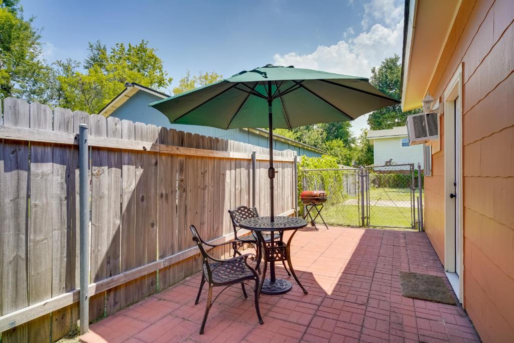 a patio with a table and chairs and an umbrella at Lake Charles Vacation Rental with Private Patio! in Lake Charles