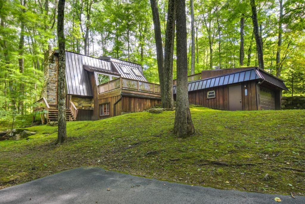 a house in the woods with trees at Family-Friendly DuBois Cabin with Community Pool! in DuBois