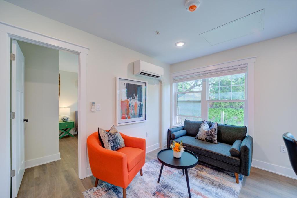 a living room with a couch and a chair and a table at DreamStay on Clay in Muskegon