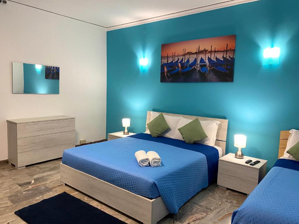 a blue bedroom with a bed with shoes on it at venice popular residence in Mestre