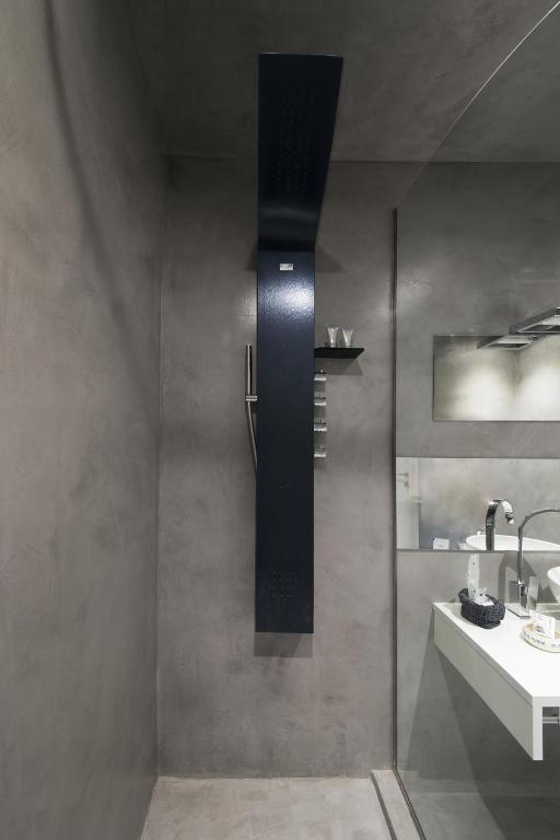 a bathroom with a sink and a mirror and a sink at Como Luxury Rooms in Como