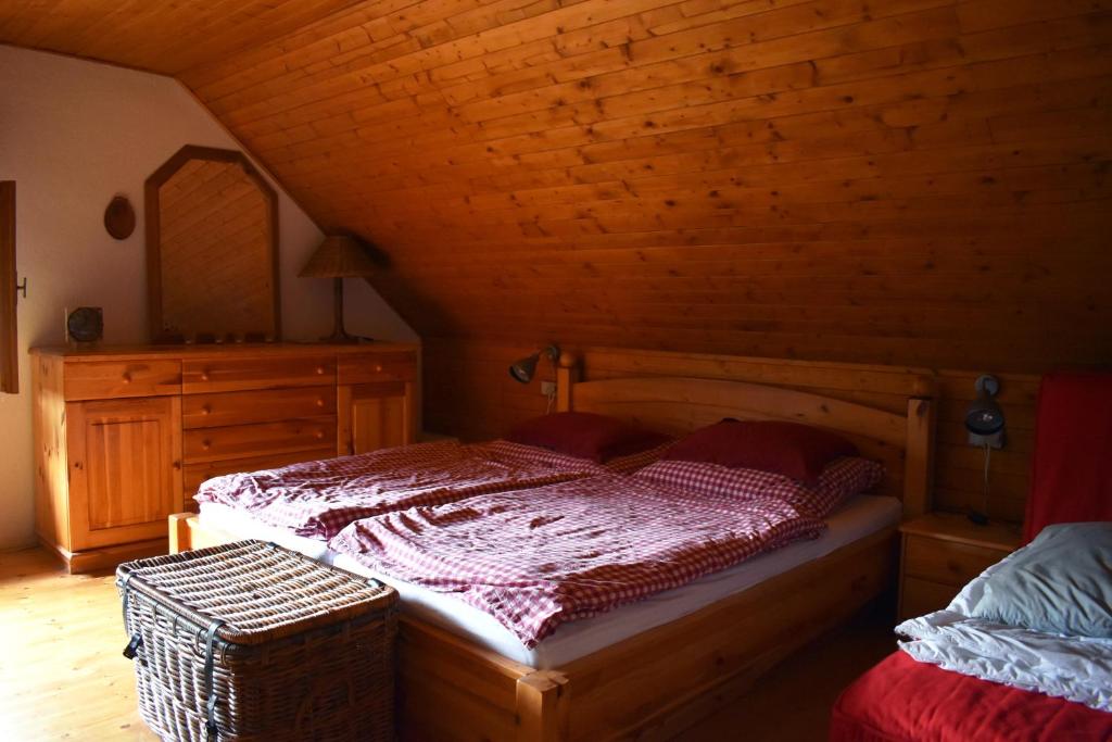 a bedroom with a bed and a wooden ceiling at Chata Potácelova 1c, Přímělkov, za mostem 200 m, druhá chata, směr Bítovčice 